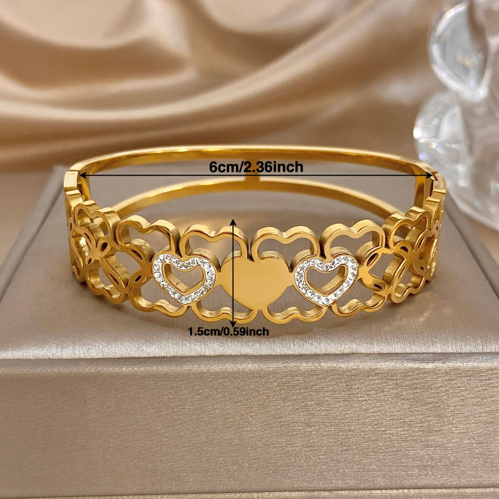 Gold cuff bangle with heart links, clear rhinestone stones; 6cm width shown