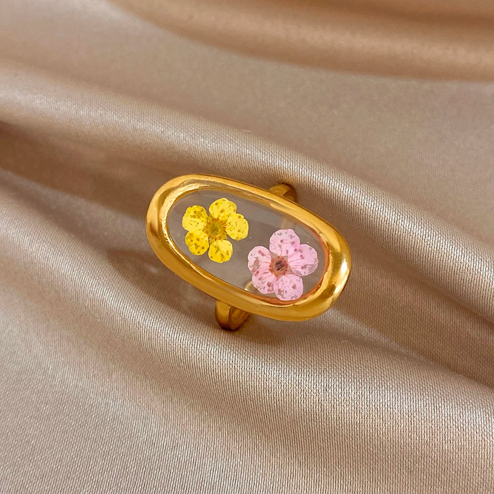 Gold-tone open oval flower ring with pink and yellow enamel blossoms