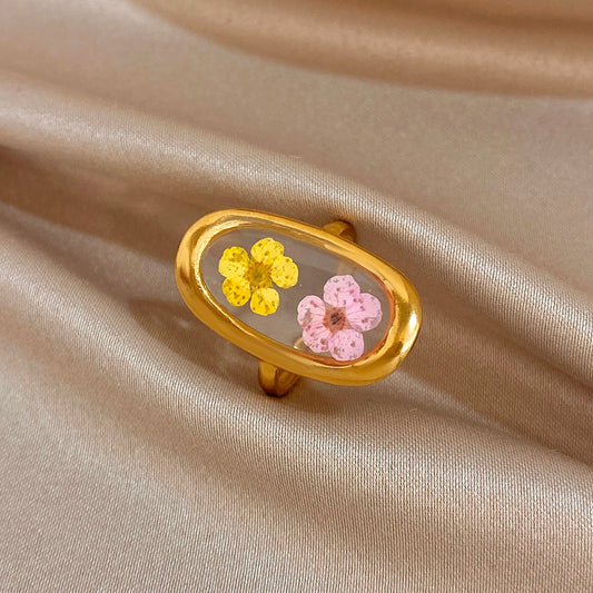 Gold-tone open oval flower ring with pink and yellow enamel blossoms