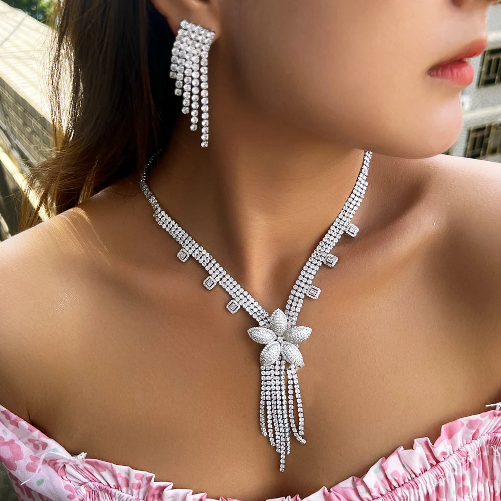 Crystal flower necklace with long tassel and matching dangle earrings, worn on model
