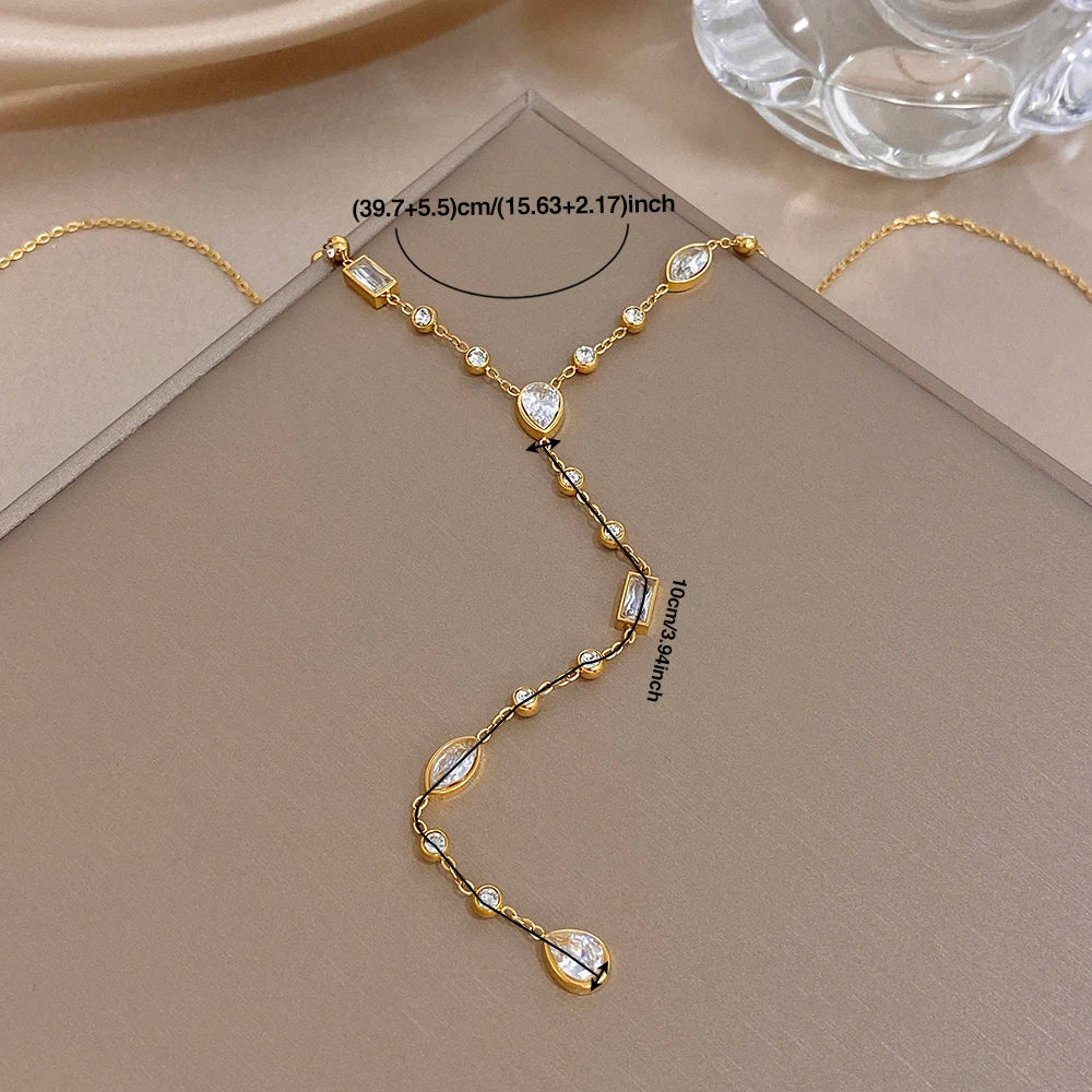 Gold-tone Y choker necklace with oval and bar crystal charms on Y-shaped chain