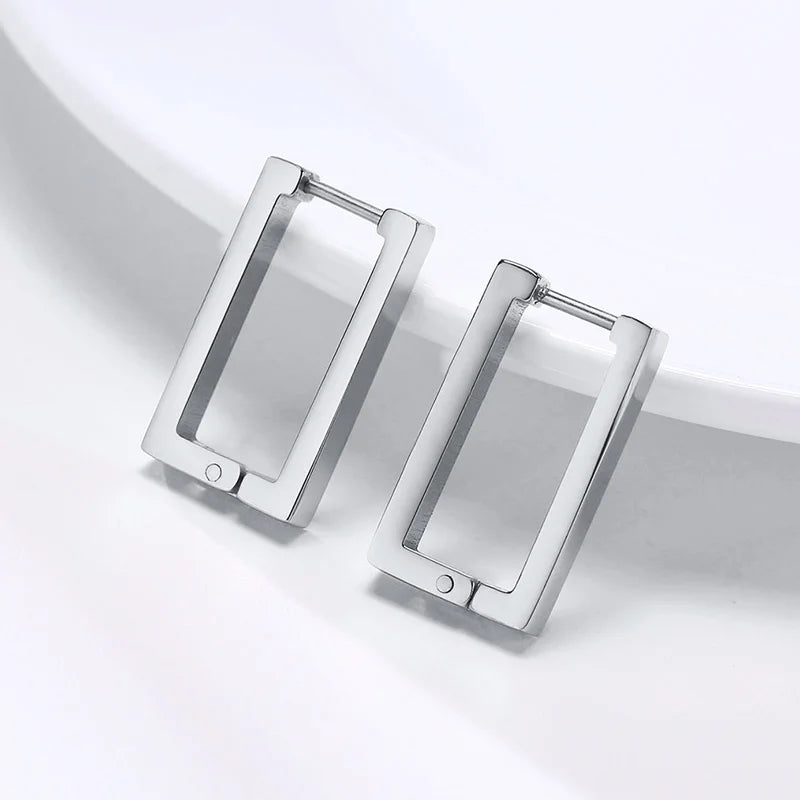 Close-up of polished silver rectangular hoop earrings with hinged clasps