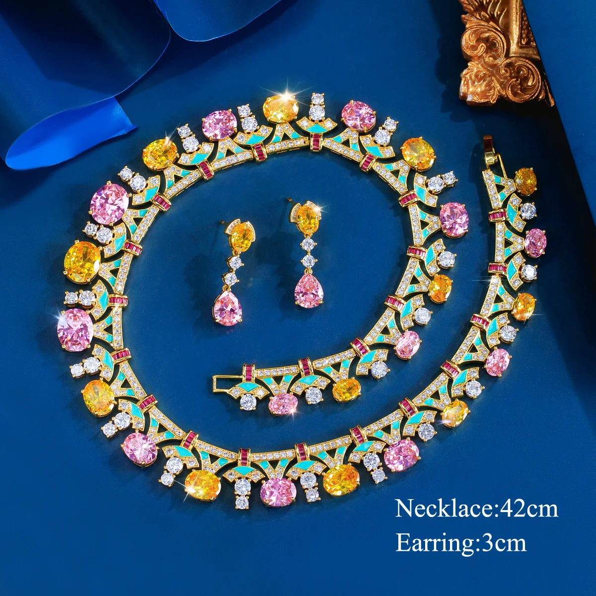 Gold-tone multicolor cubic zirconia necklace with matching drop earrings, flat lay set