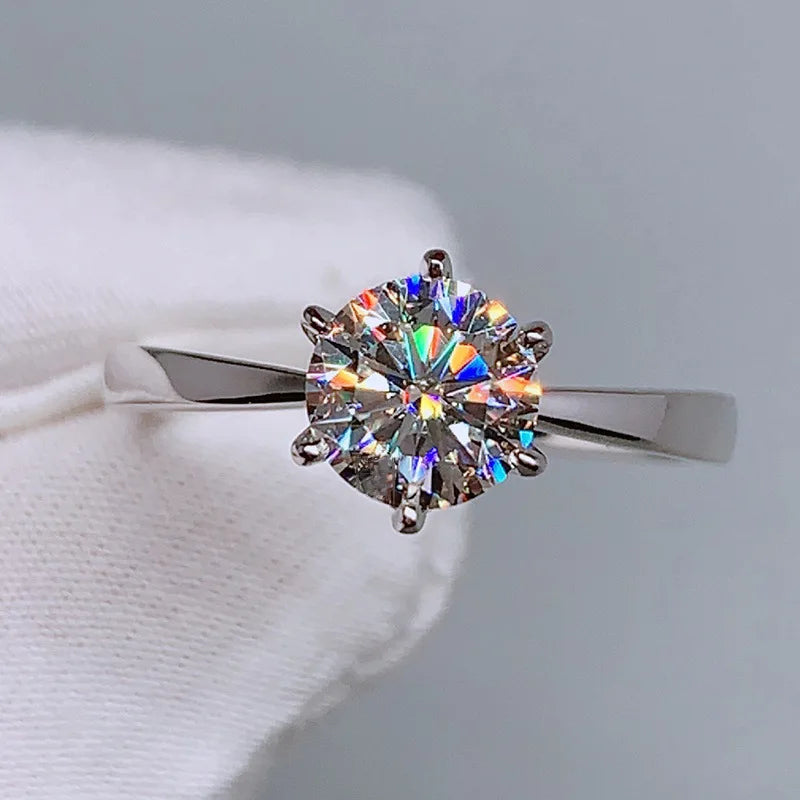 Silver-tone six-prong round cubic zirconia ring with faceted, iridescent sparkle