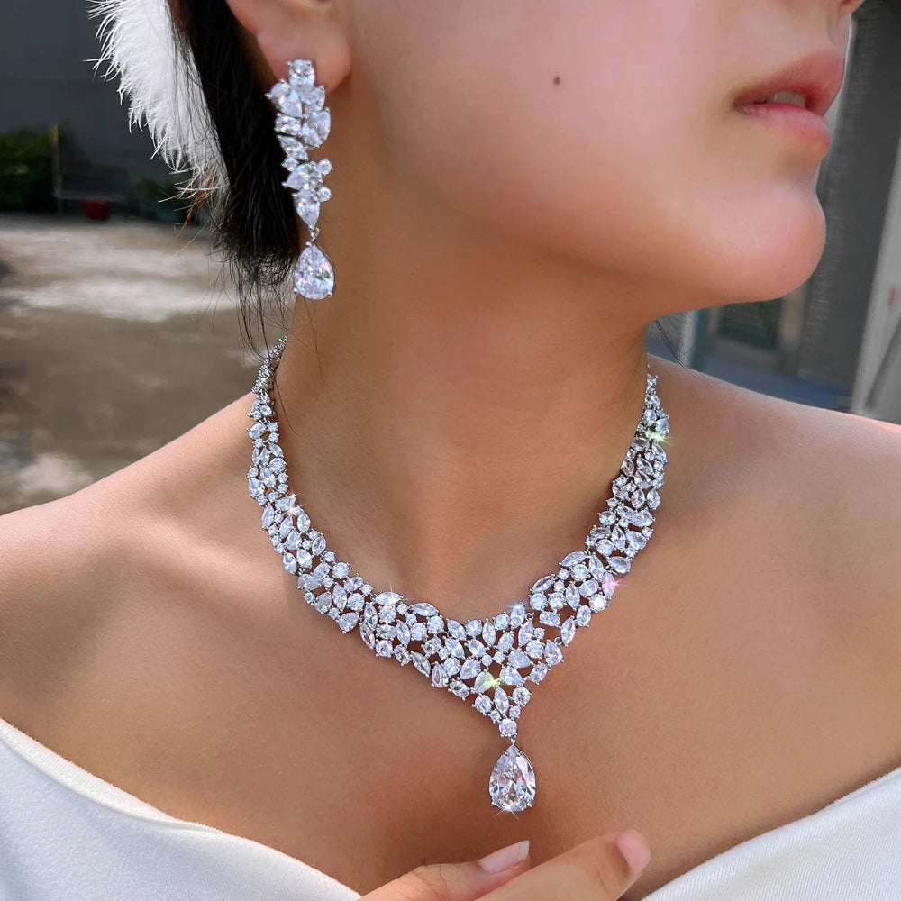 V-shaped CZ necklace and matching drop earring worn, shown close up