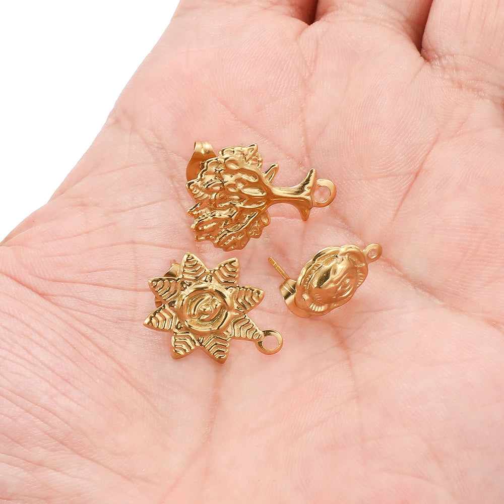 Gold sunflower stud earring charms held in hand, with loop backs, Tree of Life style
