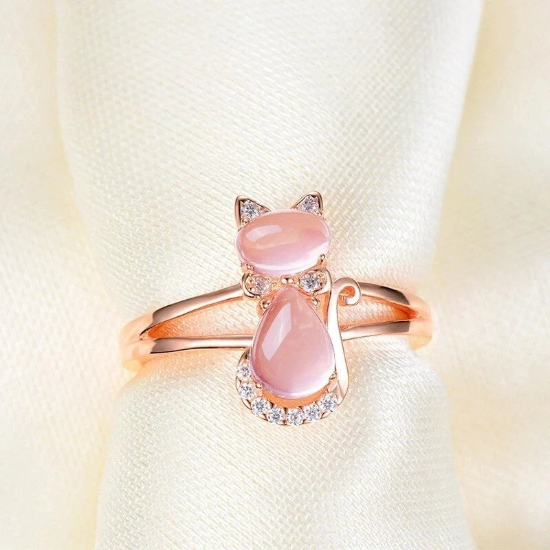 Rose gold cat motif ring with pink oval center stone and clear side sparkles