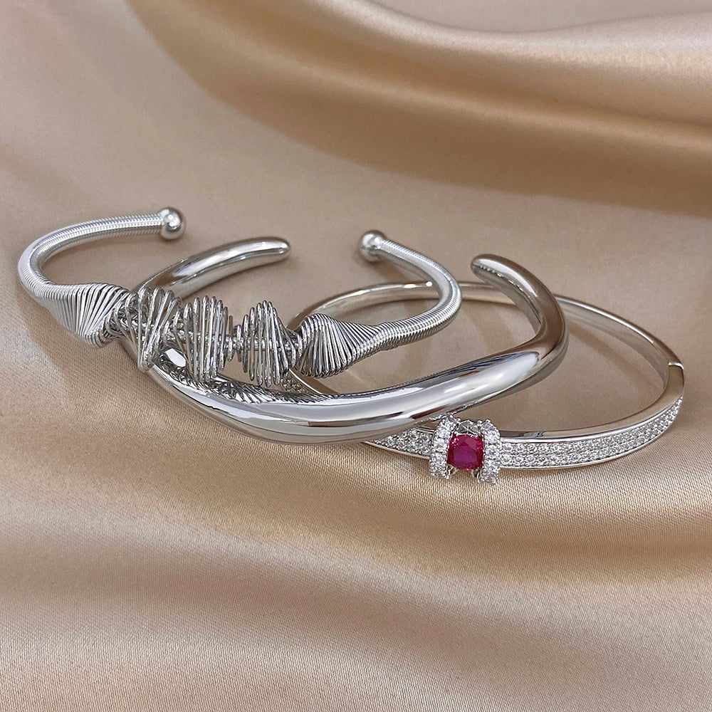Silver cuff bangle set with textured wave bracelet and crystal bar with red gemstone