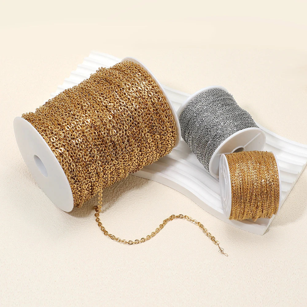 Gold and silver textured chain mesh on spools with dangling links