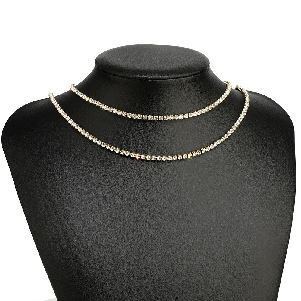 Cubic zircon chain necklaces in gold-toned and silver-toned on black mannequin bust