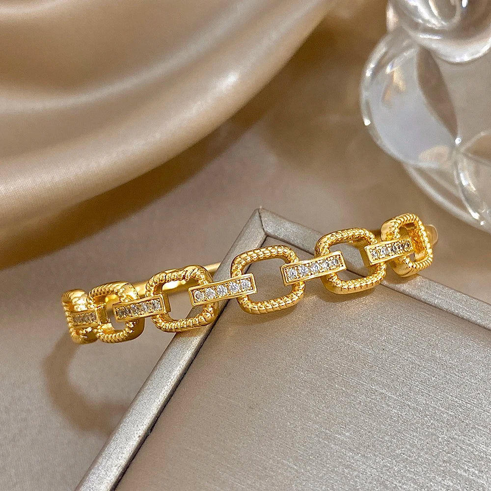 Gold-tone geometric bracelet with square zircon panels and interlocking links