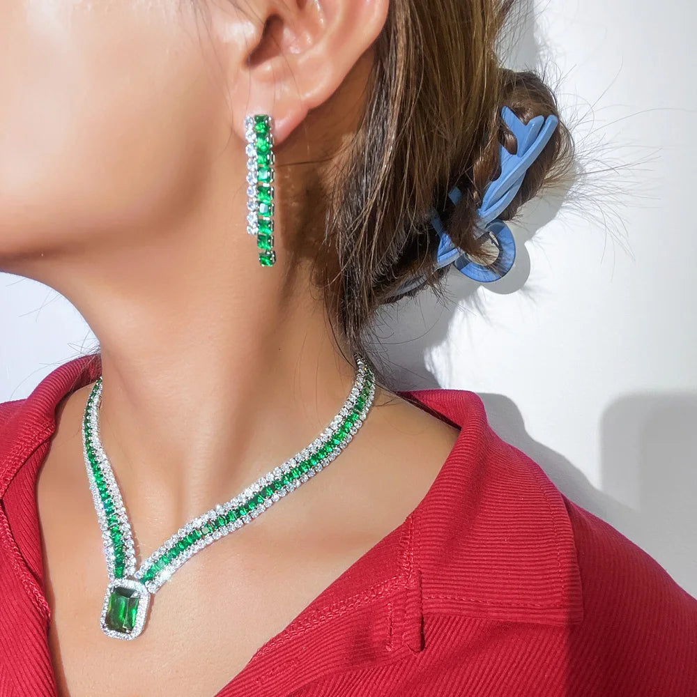 Green cubic zirconia rectangle pendant necklace and drop earrings worn, side view