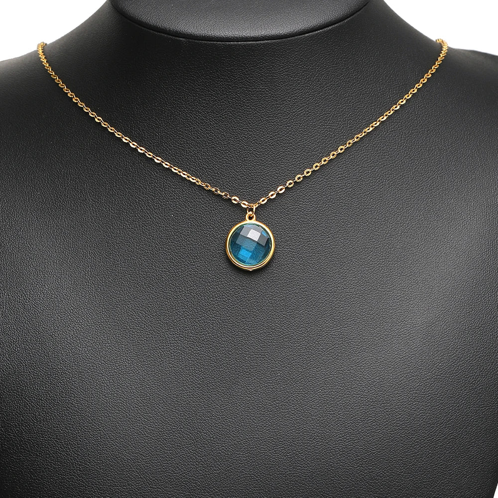 Gold-tone chain necklace with a blue round faceted glass pendant charm