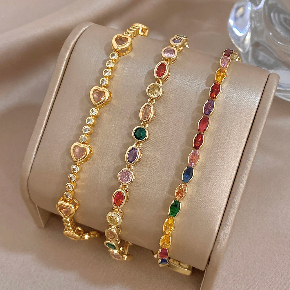 Gold-plated charm bracelet with multicolor oval zircon stones and heart accents