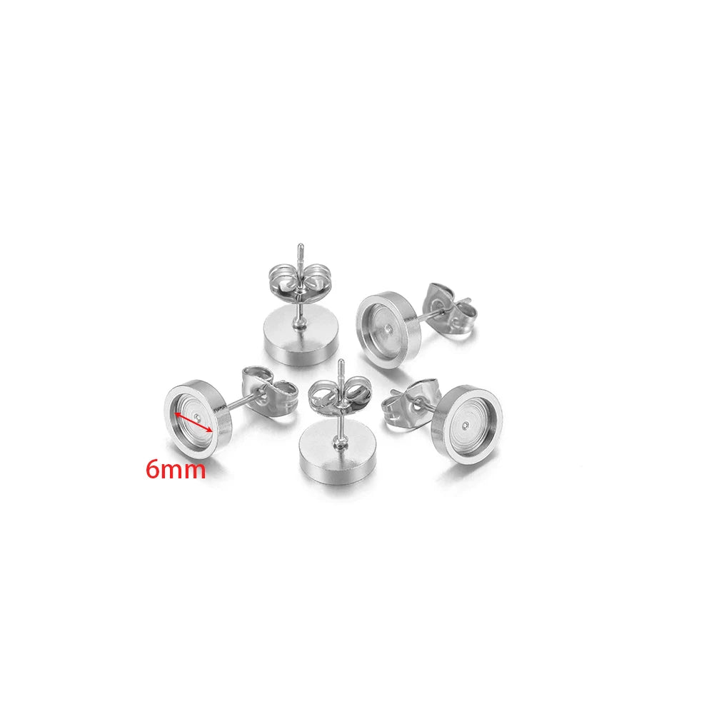 Steel-tone round stud earring bases, 6mm size marking visible, with posts and backs