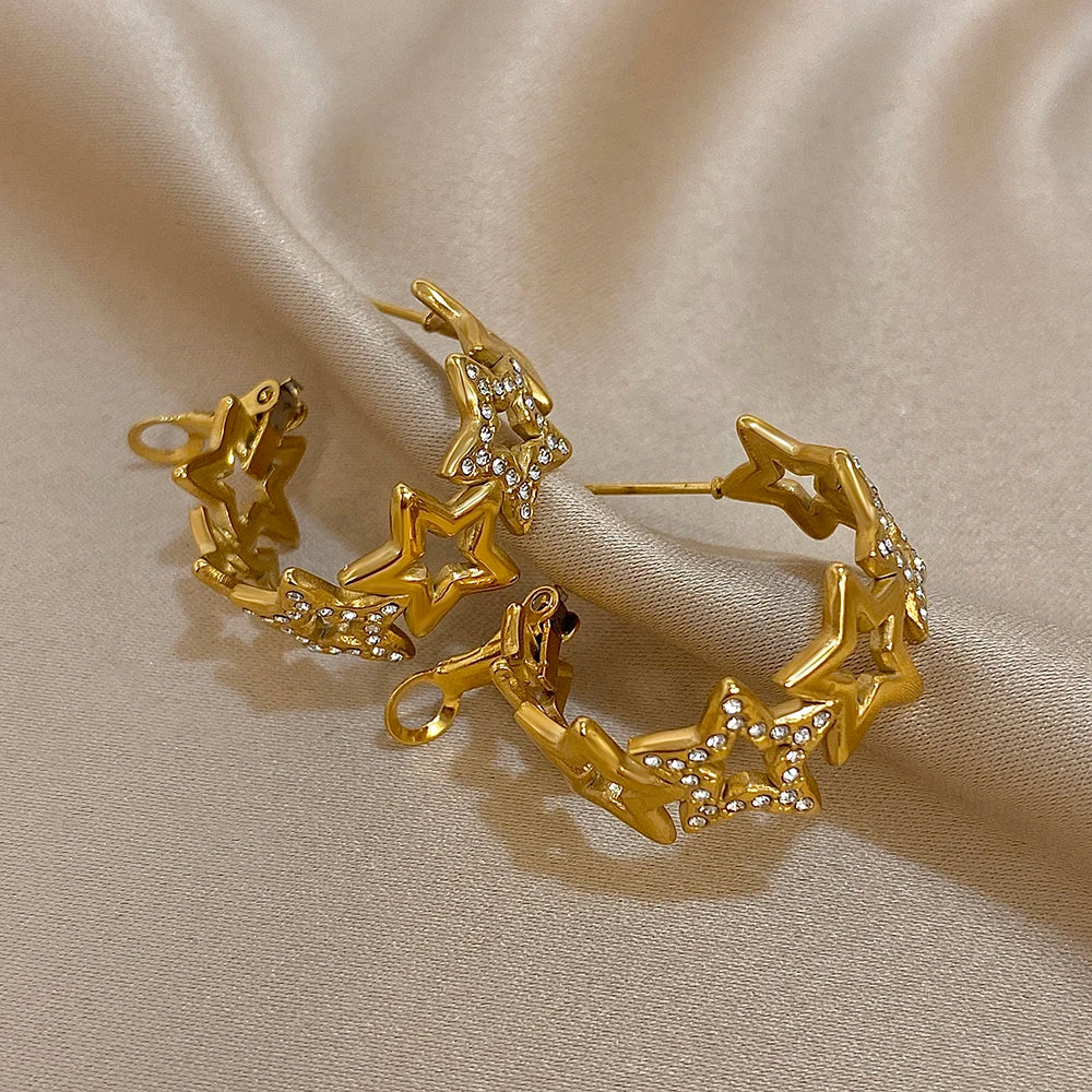 Gold-tone star hoop earrings viewed from the back, showing posts and clasp details