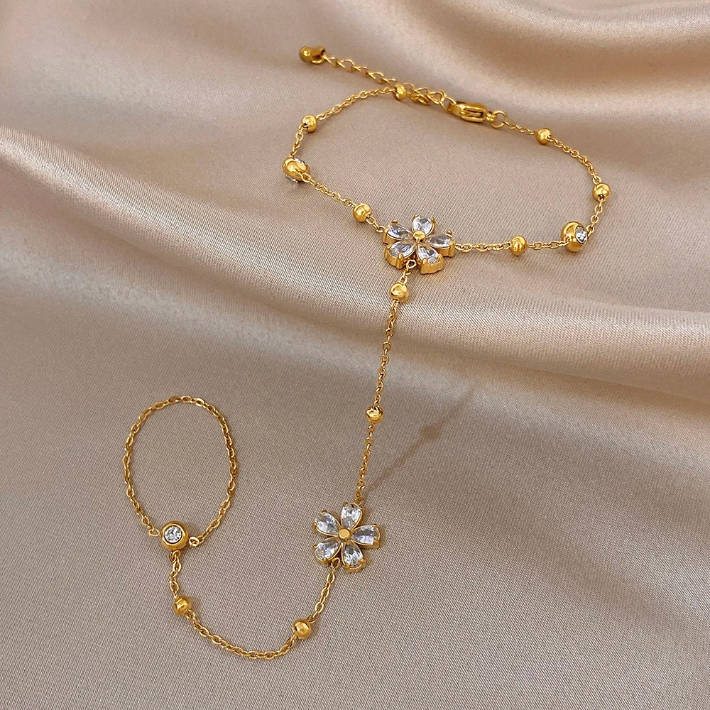 Gold-plated flower charm bracelet with separate linked finger ring