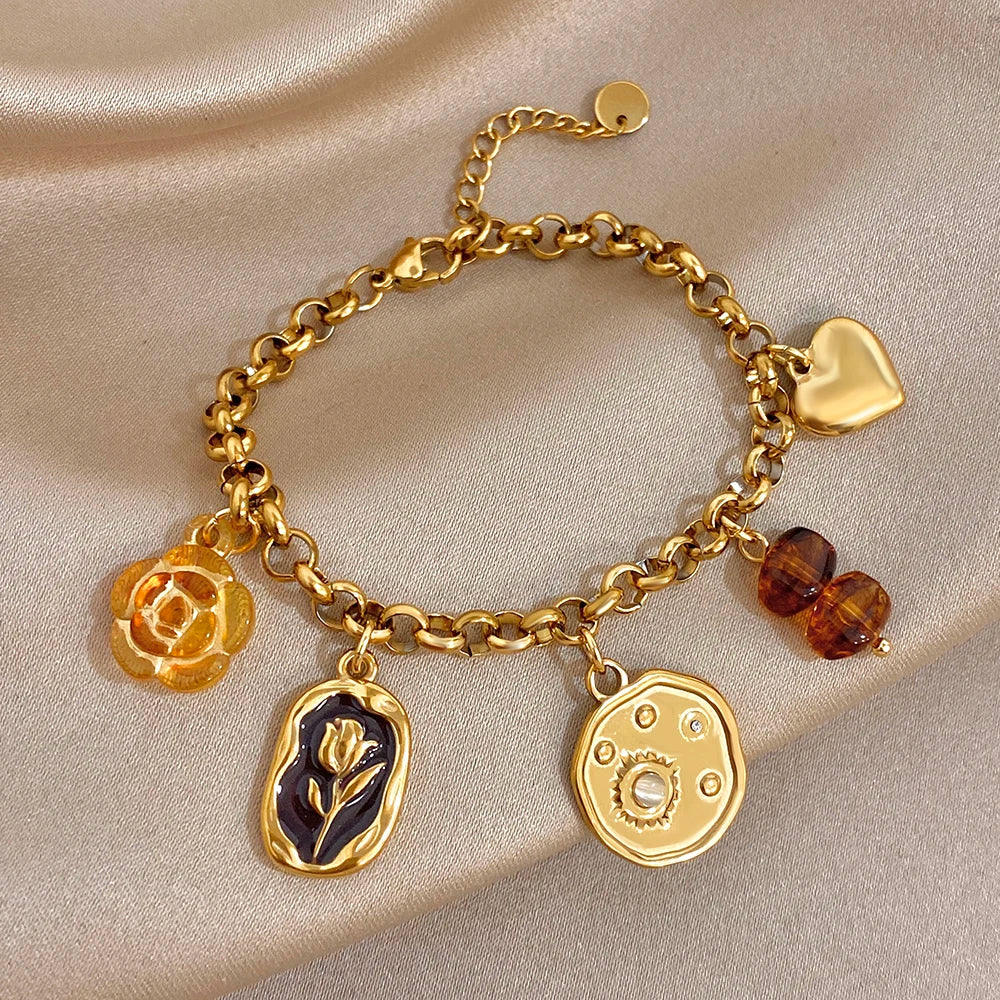 Gold plated charm wrist bracelet with heart, rose, leaf, and amber bead accents