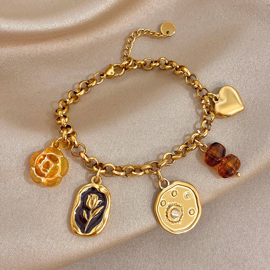 Gold plated charm wrist bracelet with heart, rose, leaf, and amber bead accents