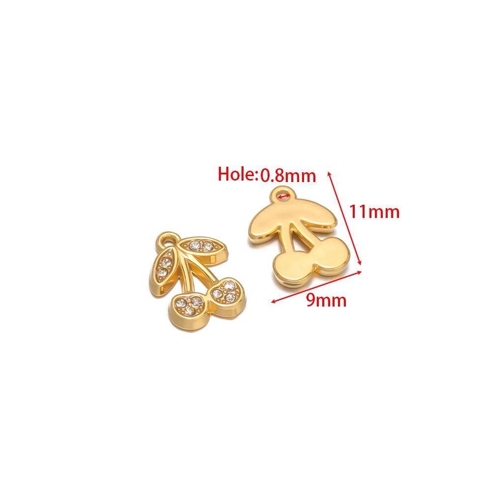 Gold-tone bird and leaf charms with red enamel and clear rhinestones