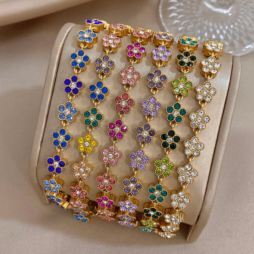 Gold-tone bracelet display with mixed-color flower zircon beads on chain links