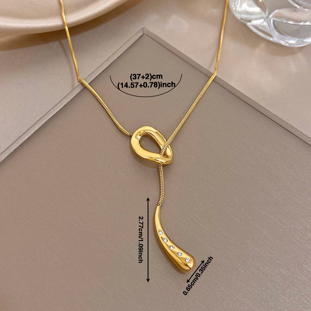 Gold knot and waterdrop pendant necklace with snake chain and sparkling rhinestone accents
