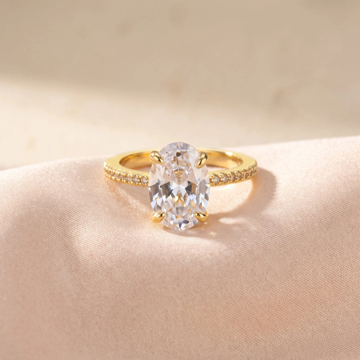 Gold-tone solitaire ring with oval-cut cubic zirconia and slim band