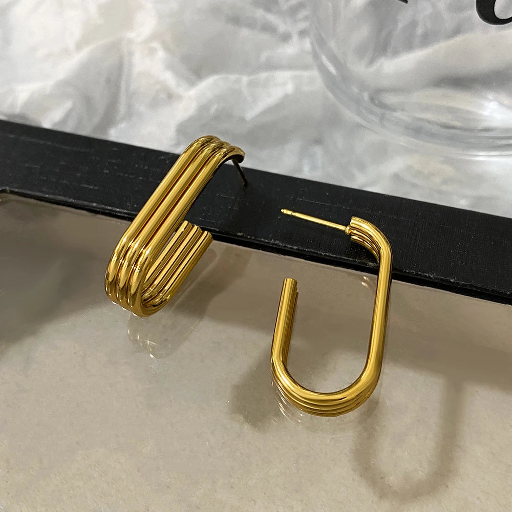 Pair of gold-tone U-shaped hoop earrings with layered ridges and post closures