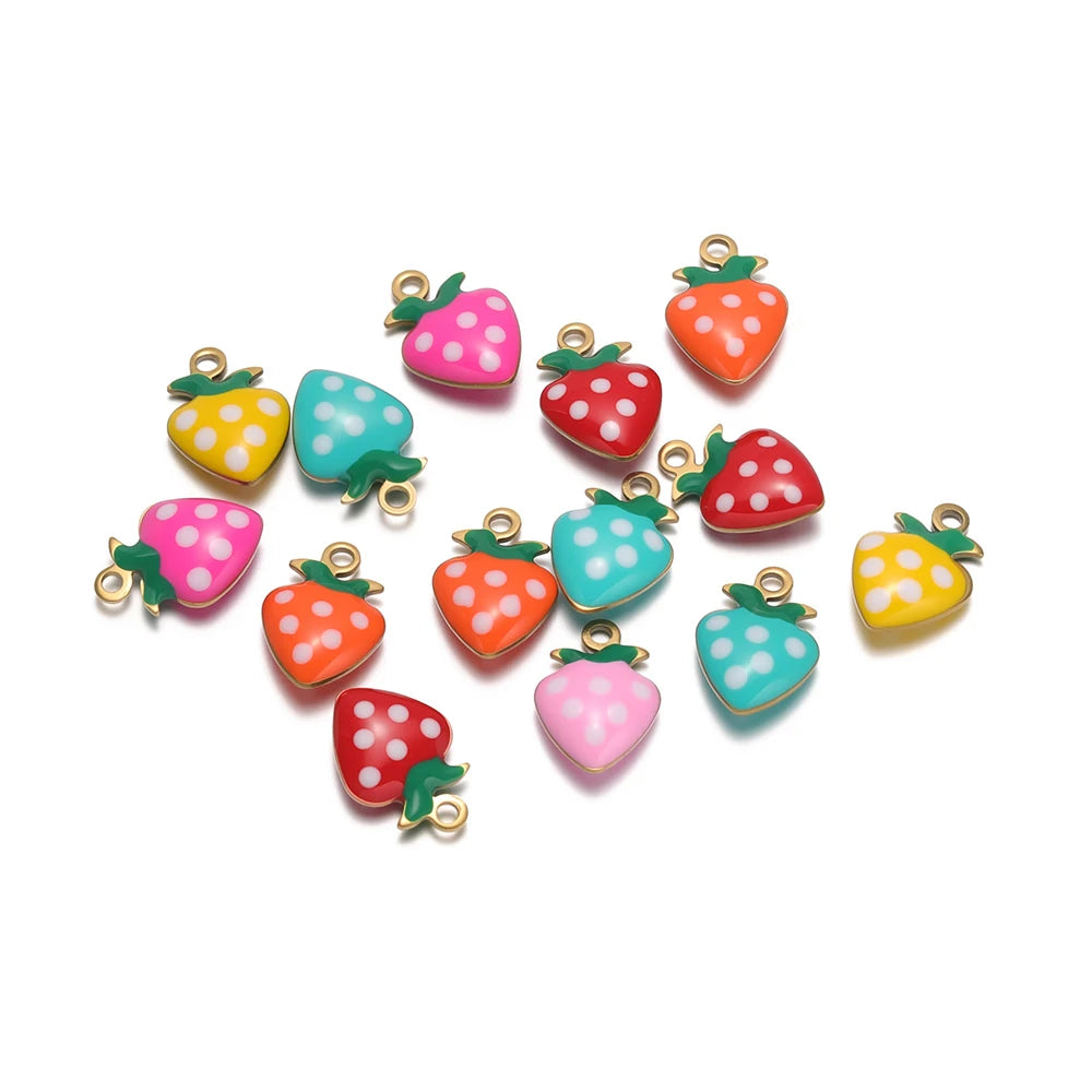 Assorted strawberry charms in teal, pink, red, and yellow with gold-tone loops and polka dots