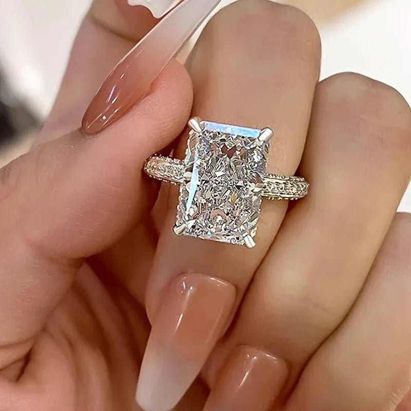 Rectangle-cut CZ ring on finger with large clear stone and textured silver band