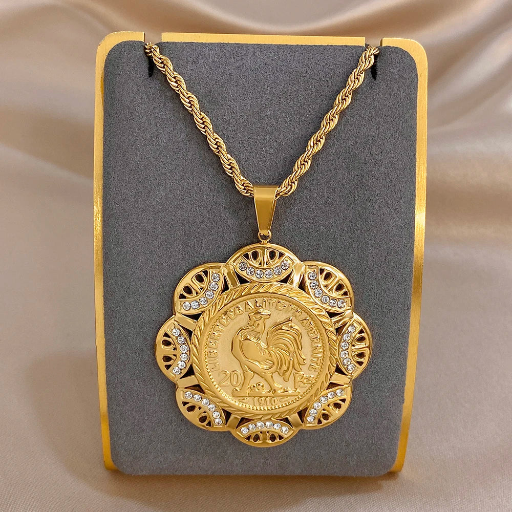 Gold-tone round coin pendant necklace with rhinestone halo and lion profile center