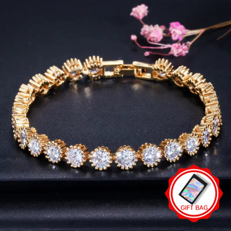 Gold-tone halo CZ tennis bracelet with gift bag icon