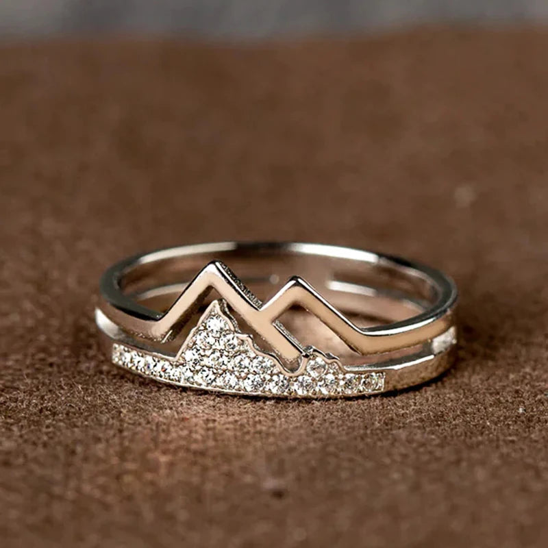 Silver-tone mountain-shaped cubic zirconia ring with zigzag band detail