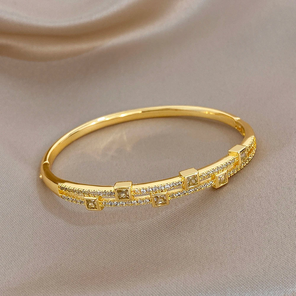 Gold-tone rhinestone cuff bracelet with square link row design, front view