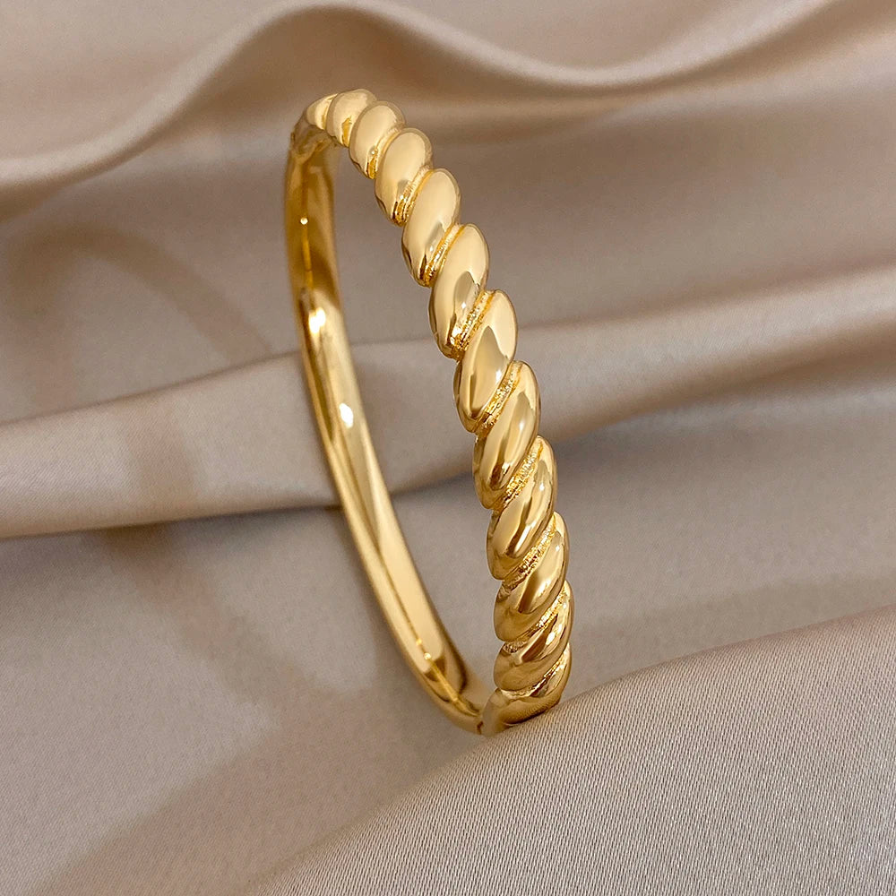 Gold-tone twisted cuff bangle with smooth rounded bead-like segments