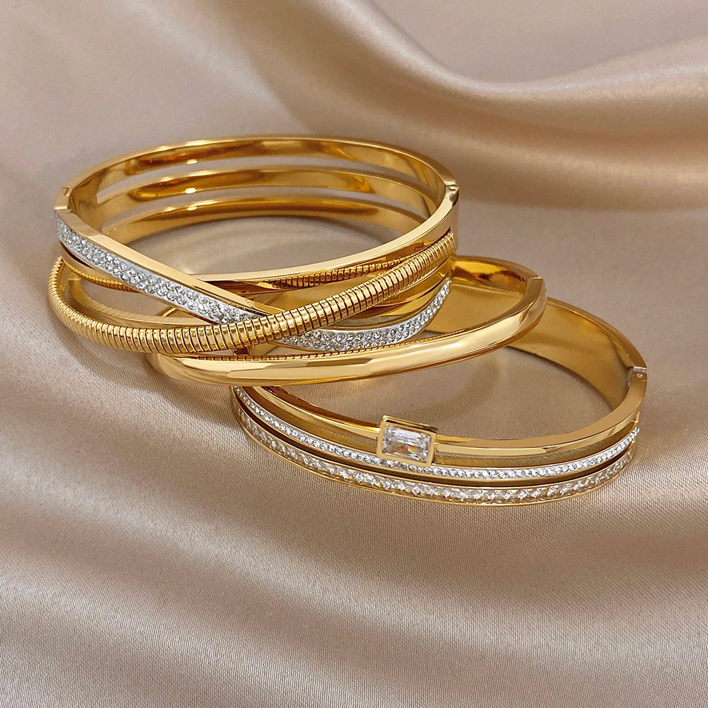 Gold-plated cuff bangles with rhinestone accents and a square crystal detail