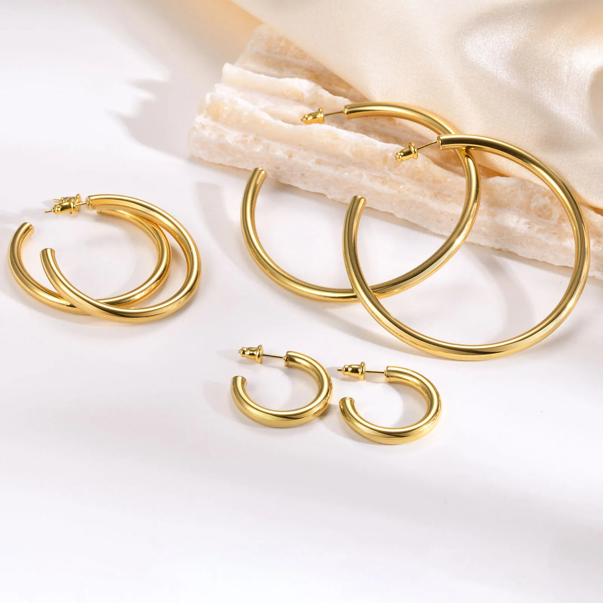 Gold chunky open hoop earrings in three sizes