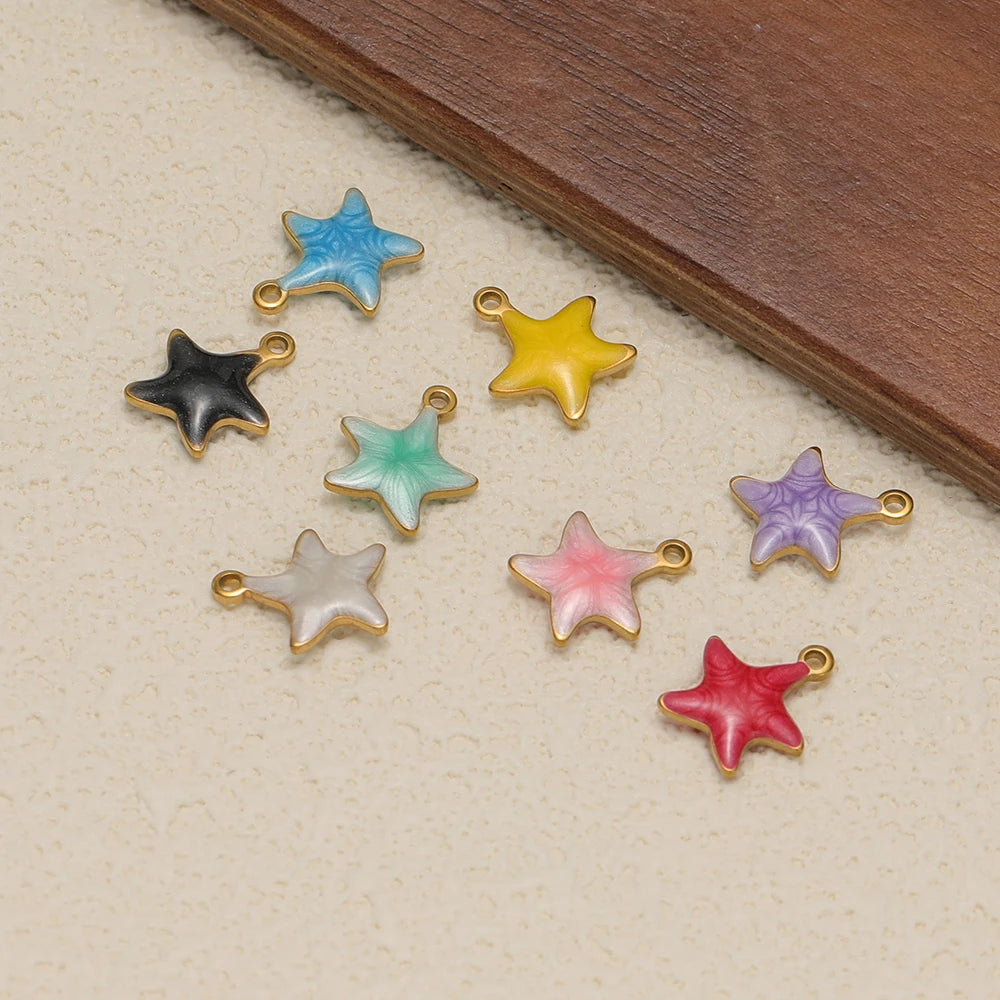 Multicolor enamel star charms with gold-tone loops, assorted colors on display