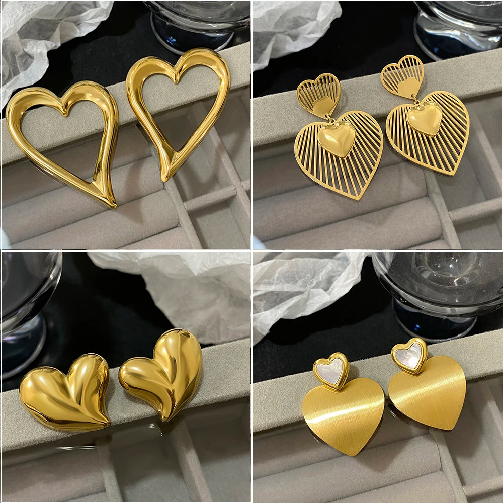 Gold heart earrings in four styles: open outline, striped drops, and solid heart studs