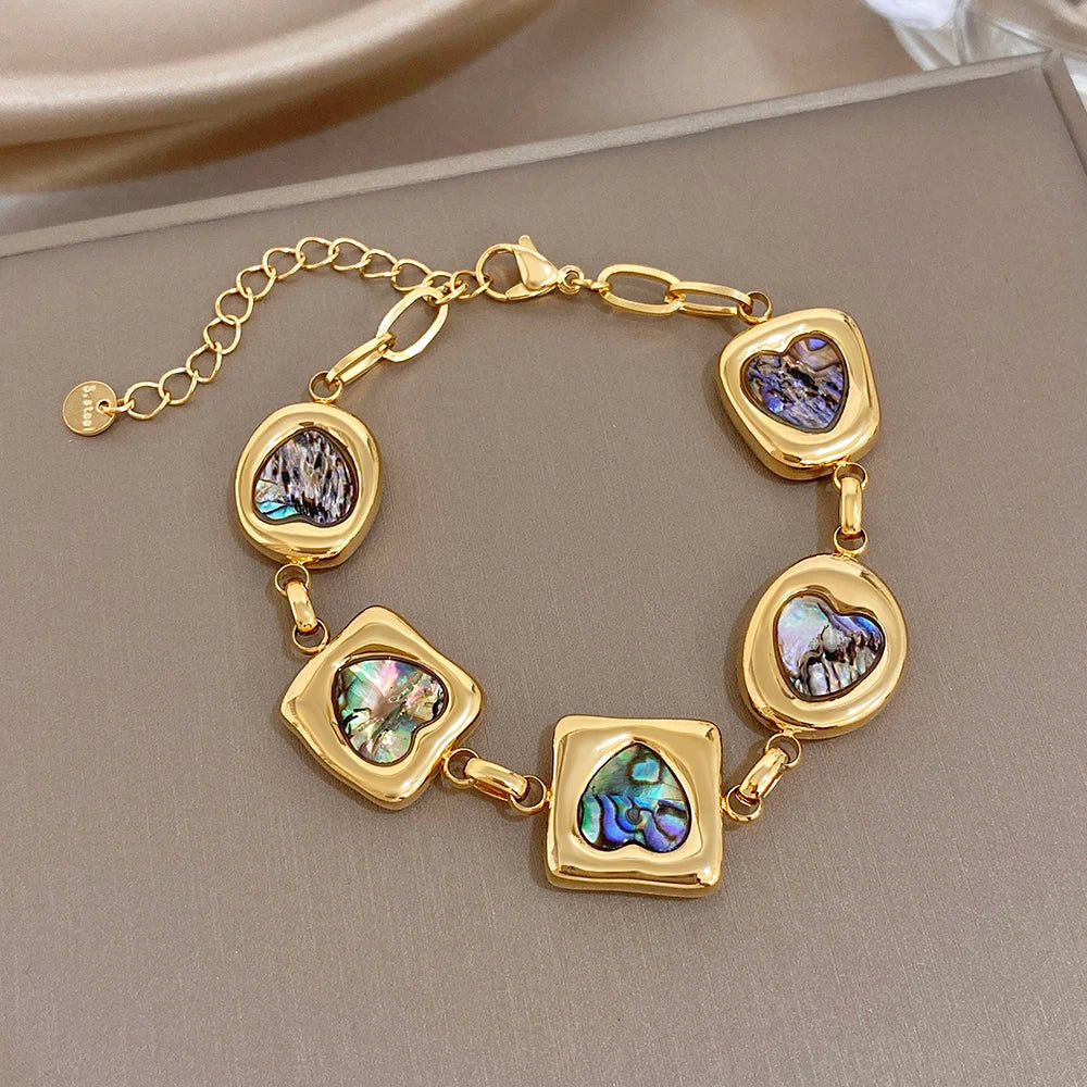 Gold plated geometric charm bracelet with iridescent abalone shell inlaid squares
