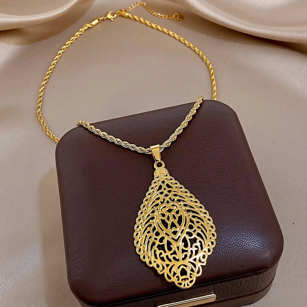 Gold plated hollow filigree teardrop pendant necklace with ornate lattice pattern