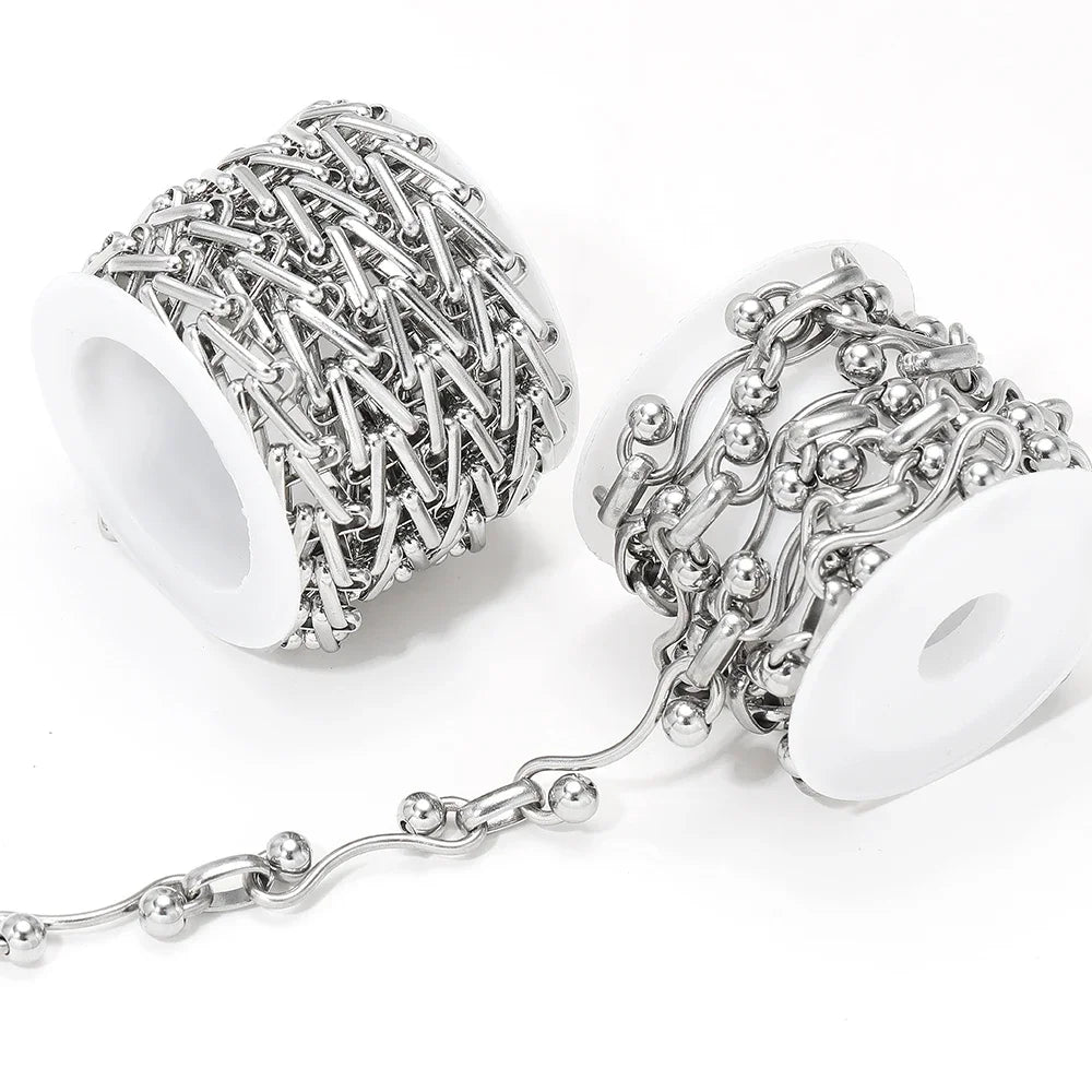 Stainless steel chain necklace on white holders, bar-link strands with round accents