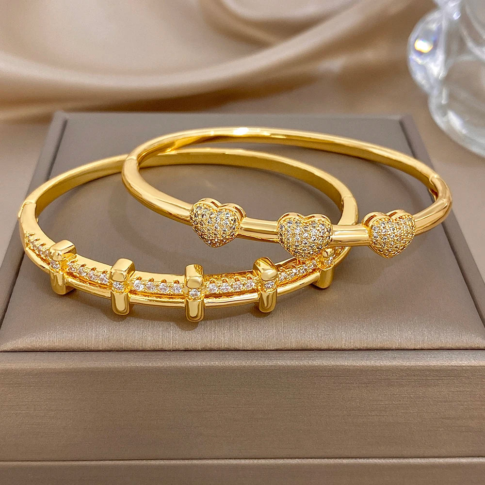Set of two gold-tone zircon cuff bangles with round pave bead and bar links