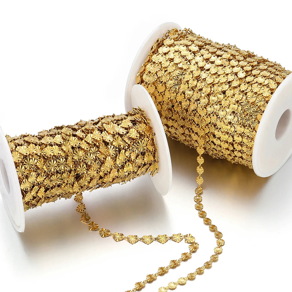 Gold heart-shaped embossed chain lengths shown hanging from two spools