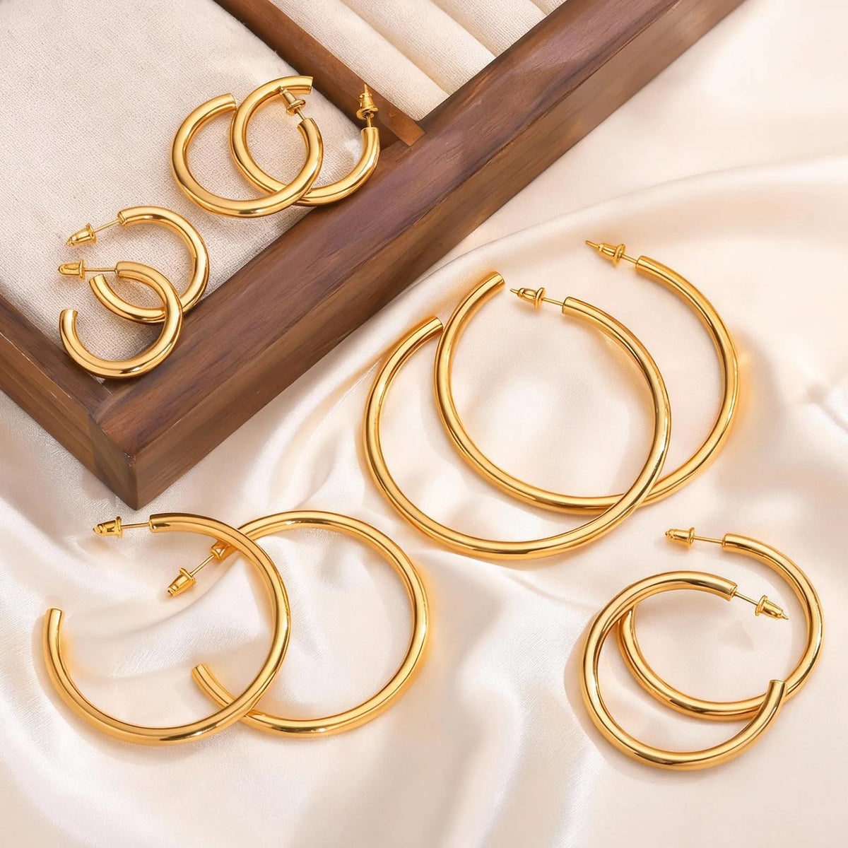 Gold chunky open hoop earrings in several sizes