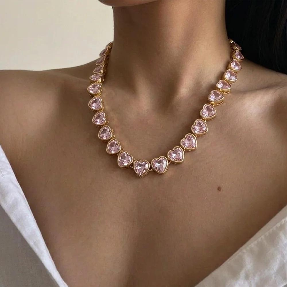 Pink heart zircon link chain choker on model’s neck, gold-tone links