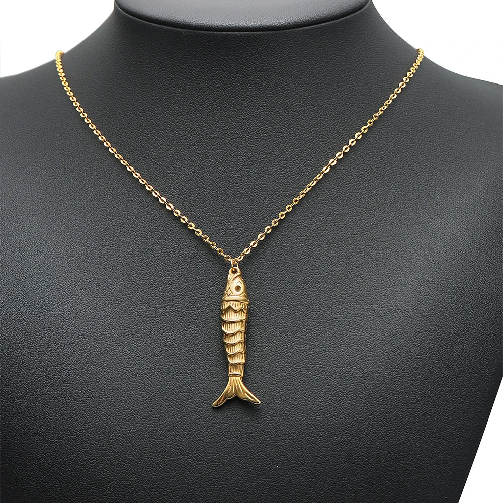 Gold-tone fish charm pendant hanging from a chain necklace