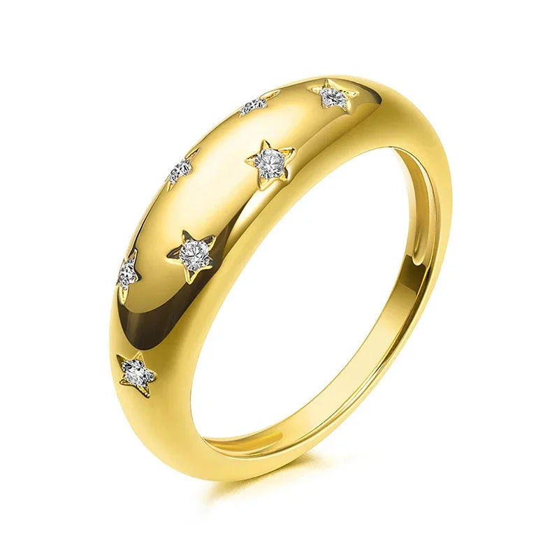 Gold-tone wedding band ring with star-shaped inlays and small sparkle stones
