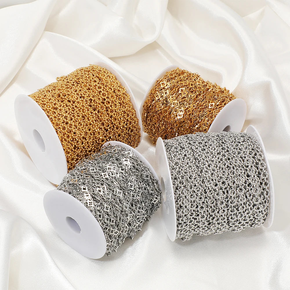 Assorted square-link chains on multiple white spools: gold, steel, and silver tones
