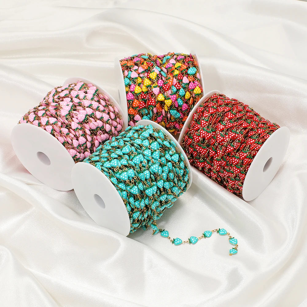 Assorted enamel strawberry charm chain spools in pink, turquoise, and red for DIY jewelry